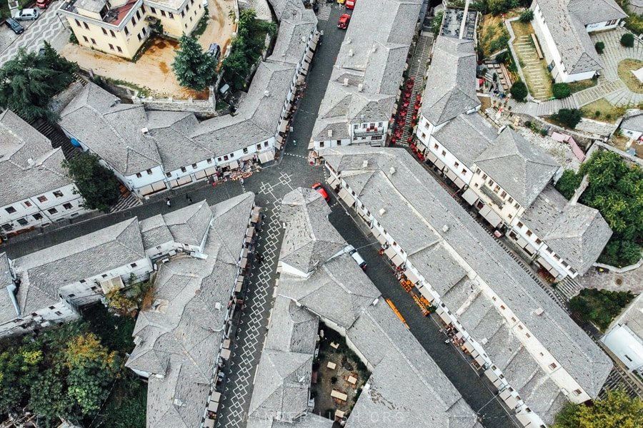 Aerial view of Gjirokastër: grey stone-slab roofs over narrow paved streets